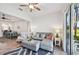 The living room shows neutral décor and a ceiling fan, next to an adjacent dining area at 2471 Kensington Greens Dr, Sun City Center, FL 33573