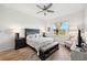 Inviting main bedroom with a queen bed, accent bench, and a calming view through a bright window at 2471 Kensington Greens Dr, Sun City Center, FL 33573