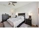 Comfortable main bedroom featuring wood floors and classic, dark wood furniture with an attached bench at 2471 Kensington Greens Dr, Sun City Center, FL 33573