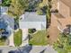 High-angle shot of a house with a neat lawn, showing the roof and a driveway amidst a residential street at 2555 68Th S Ave, St Petersburg, FL 33712