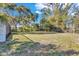 Large, grassy backyard with mature trees, offering plenty of space for outdoor activities at 2555 68Th S Ave, St Petersburg, FL 33712