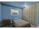 Blue bedroom with large closet featuring bi-fold doors, and a window at 2555 68Th S Ave, St Petersburg, FL 33712