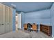 Blue bedroom with large closet featuring bi-fold doors, a desk and chair at 2555 68Th S Ave, St Petersburg, FL 33712