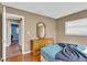 Cozy bedroom featuring neutral walls, wood floors, and a wooden dresser with an ornate mirror at 2555 68Th S Ave, St Petersburg, FL 33712