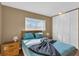 Bedroom featuring wood floors, tan walls, closet with bi-fold doors, and two windows at 2555 68Th S Ave, St Petersburg, FL 33712