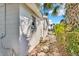 Exterior view showing the side of the house and walkway with lush landscaping at 2555 68Th S Ave, St Petersburg, FL 33712