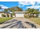 Spacious driveway leading to a two-car garage and an attractive lawn at 2555 68Th S Ave, St Petersburg, FL 33712