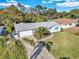 Cozy one-story home featuring a large, green front lawn, driveway, and beautifully landscaped front yard at 2555 68Th S Ave, St Petersburg, FL 33712