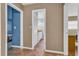 Hallway view showing access to a bedroom and a bathroom with neutral walls and tile floors at 2555 68Th S Ave, St Petersburg, FL 33712