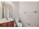 Clean half-bathroom featuring a marble-top vanity and a well-maintained toilet and toilet paper holder at 26850 Juniper Bay Dr, Wesley Chapel, FL 33544