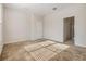 Bare bedroom showing light shining through blinds and an open door to the bathroom area at 26850 Juniper Bay Dr, Wesley Chapel, FL 33544