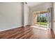 Bright bedroom featuring hardwood flooring, ample natural light, and a sliding glass door to an outdoor patio at 26850 Juniper Bay Dr, Wesley Chapel, FL 33544