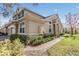 Exterior shot of the end unit townhome showing brick walkway, green lawn, and well-maintained landscaping at 26850 Juniper Bay Dr, Wesley Chapel, FL 33544