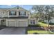 Two-story home with a two-car garage and brick driveway and well manicured lawn at 26850 Juniper Bay Dr, Wesley Chapel, FL 33544