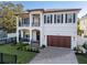 Stunning two-story home with a two-car garage, lush landscaping, and beautiful black shutters at 2810 W Alline Ave, Tampa, FL 33611