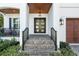 Welcoming front entrance with a stylish black multi-pane front door and brick-paved steps at 2810 W Alline Ave, Tampa, FL 33611