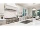 Close up of the kitchen island, cooktop, and modern faucet at 2810 W Alline Ave, Tampa, FL 33611