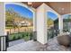 Charming covered porch area with brick flooring, black railings, and outdoor seating at 2810 W Alline Ave, Tampa, FL 33611