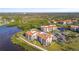 Aerial view of the community, with condo buildings and the lake view in the background at 301 Mariner Dr # 301, Tarpon Springs, FL 34689