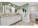 Inviting bathroom with a double sink vanity, granite countertops and a glass-enclosed shower at 301 Mariner Dr # 301, Tarpon Springs, FL 34689