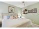 Airy bedroom with a comfortable bed, decorative shelves, and calming pastel-green walls at 301 Mariner Dr # 301, Tarpon Springs, FL 34689