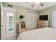 Well-lit bedroom featuring a closet, dresser, and ensuite bathroom, creating a comfortable and functional space at 301 Mariner Dr # 301, Tarpon Springs, FL 34689