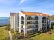 Stunning condominium building featuring a red tile roof and multiple balconies with views of the water at 301 Mariner Dr # 301, Tarpon Springs, FL 34689