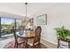 Cozy dining area featuring a wood table, rattan chairs and a stained glass chandelier at 301 Mariner Dr # 301, Tarpon Springs, FL 34689