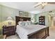 Spacious main bedroom features a ceiling fan, dark wood furniture, and carpeted floors at 301 Mariner Dr # 301, Tarpon Springs, FL 34689