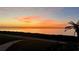 Beautiful water view with colorful sunset sky and lush landscaping at 301 Mariner Dr # 301, Tarpon Springs, FL 34689