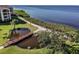 Waterfront view with a walking path and pond featuring a charming bridge and lush greenery at 301 Mariner Dr # 301, Tarpon Springs, FL 34689