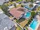 Aerial view of home with screened-in pool, fenced yard, and well-manicured landscaping at 3116 Swan Ln, Safety Harbor, FL 34695