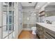 Modern bathroom featuring a glass enclosed shower, wood cabinets, and wood-look tile flooring at 3116 Swan Ln, Safety Harbor, FL 34695