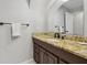 Bathroom vanity featuring granite countertop, dark wood cabinets, and modern faucet at 3116 Swan Ln, Safety Harbor, FL 34695