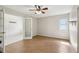 Well-lit bedroom with neutral walls, ceiling fan, and wood-look flooring at 3116 Swan Ln, Safety Harbor, FL 34695