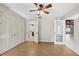 Bright bedroom with wood-look floors, ceiling fan, and spacious closet at 3116 Swan Ln, Safety Harbor, FL 34695