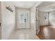 Inviting entryway featuring decorative glass door, tile flooring, and convenient coat hooks at 3116 Swan Ln, Safety Harbor, FL 34695