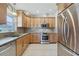 Bright kitchen featuring stainless steel appliances, granite countertops, and ample cabinet space at 3116 Swan Ln, Safety Harbor, FL 34695