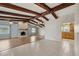 Open living area with a brick fireplace, exposed beams, and seamless access to the kitchen at 3116 Swan Ln, Safety Harbor, FL 34695