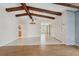 Spacious living room with exposed beams, tile flooring, and a view of the front entrance at 3116 Swan Ln, Safety Harbor, FL 34695