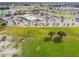 A bird's eye view of a community center, parking, and surrounding green spaces creating a welcoming atmosphere at 315 Linger Ln, Sun City Center, FL 33573