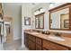 Bathroom features double sinks, a granite countertop and dark wood cabinets at 315 Linger Ln, Sun City Center, FL 33573