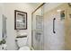 Bathroom featuring a glass door shower and decorated with a picture on the wall at 315 Linger Ln, Sun City Center, FL 33573