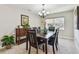 Dining room features chandelier, dining table, six chairs and large window at 315 Linger Ln, Sun City Center, FL 33573