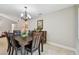 Dining room showcasing a chandelier, dining table and chairs, and wooden hutch at 315 Linger Ln, Sun City Center, FL 33573