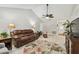 Inviting living room with a leather sofa, ceiling fan, and natural light at 315 Linger Ln, Sun City Center, FL 33573