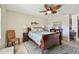 Relaxing main bedroom featuring a decorative ceiling fan, area rug, and comfortable furnishings at 315 Linger Ln, Sun City Center, FL 33573