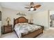 Comfortable bedroom with a decorative ceiling fan, a woven headboard, and neutral walls at 315 Linger Ln, Sun City Center, FL 33573