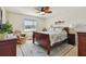 Bright main bedroom featuring a ceiling fan, large window, and stylish furnishings at 315 Linger Ln, Sun City Center, FL 33573