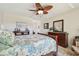 Spacious bedroom with a decorative fan, complemented by stylish decor and ample natural light at 315 Linger Ln, Sun City Center, FL 33573